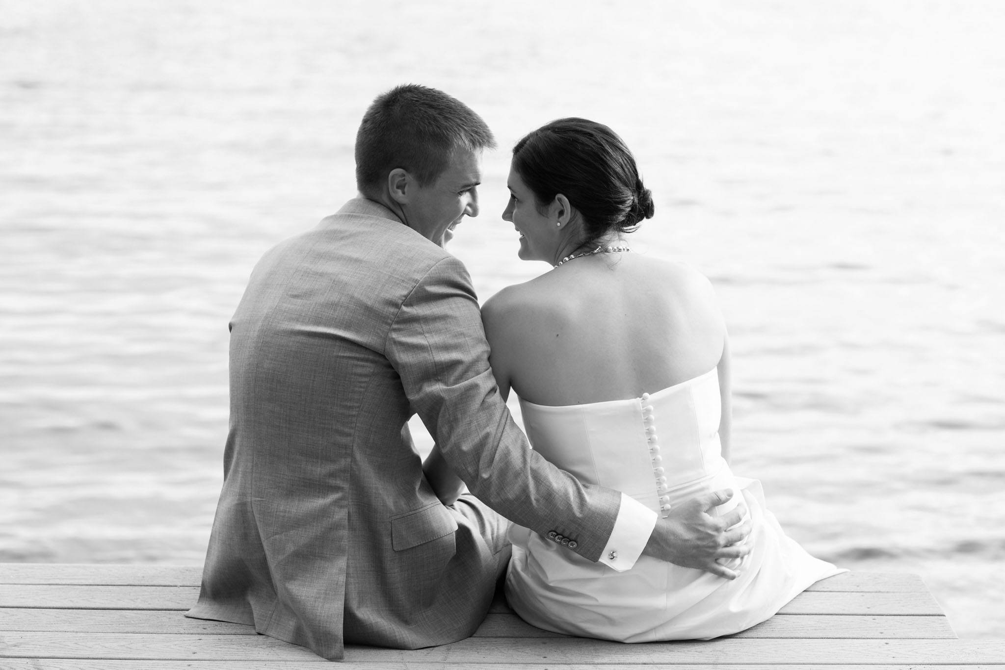bride and groom sitting on pier – North Lake Tahoe Kings Beach wedding photography