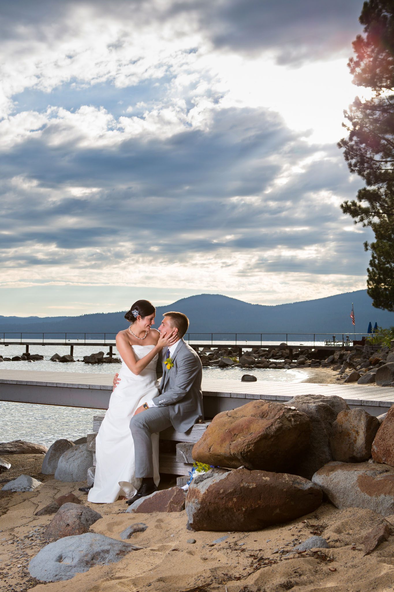 bride and groom on beach, rocks, pier – North Lake Tahoe Kings Beach wedding photography