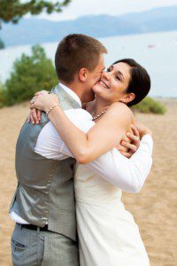 bride and groom hugging on beach – North Lake Tahoe Kings Beach wedding photography