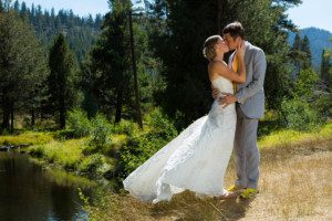 brde and groom kissing by creek – Lake Tahoe Meeks Bay wedding photography