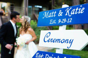 bride and groom kissing wedding sign Hyatt Lake tahoe – nina wedding photographer