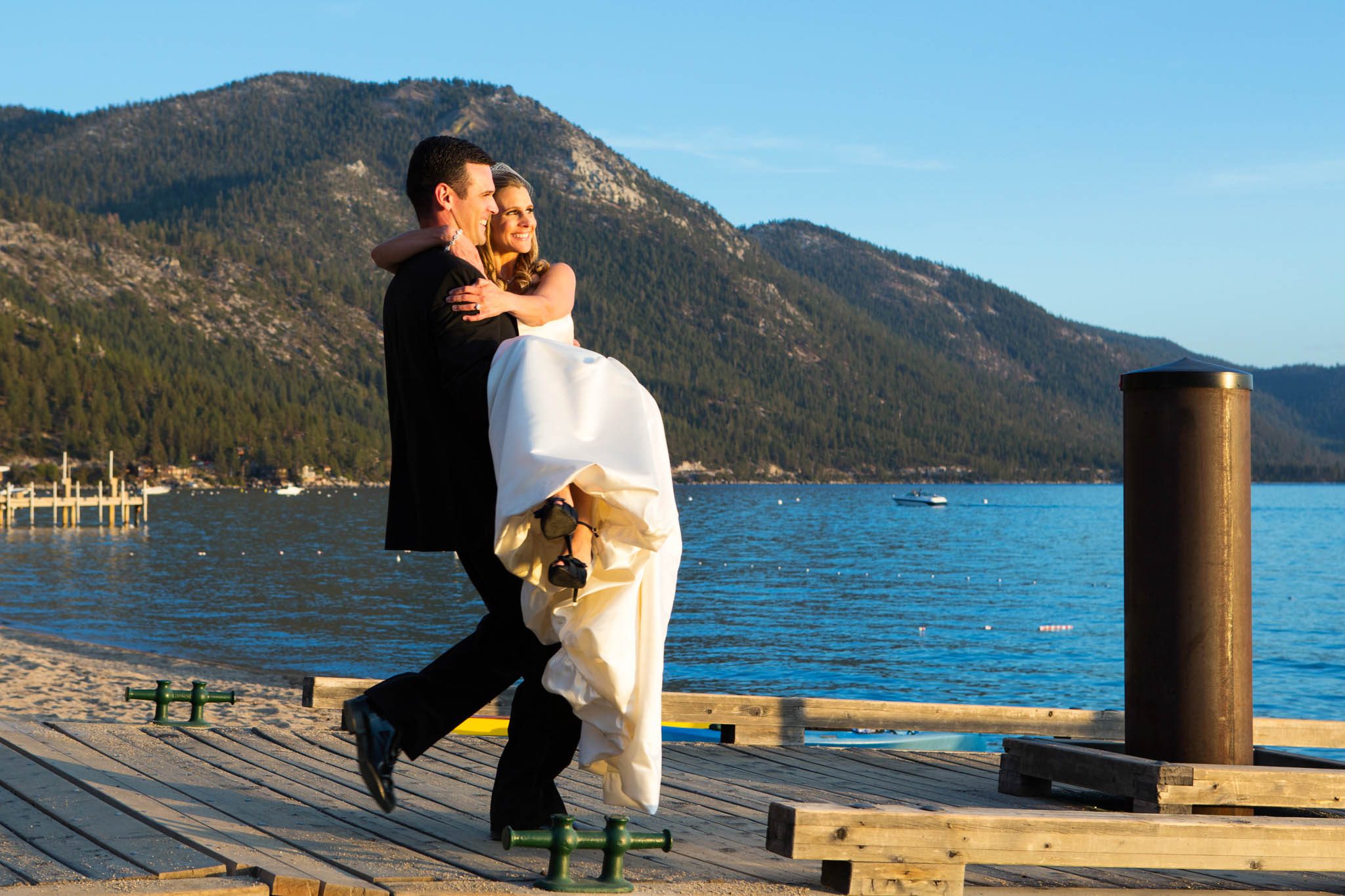 groom carrying bride on pier Lake Tahoe – nina wedding photographer