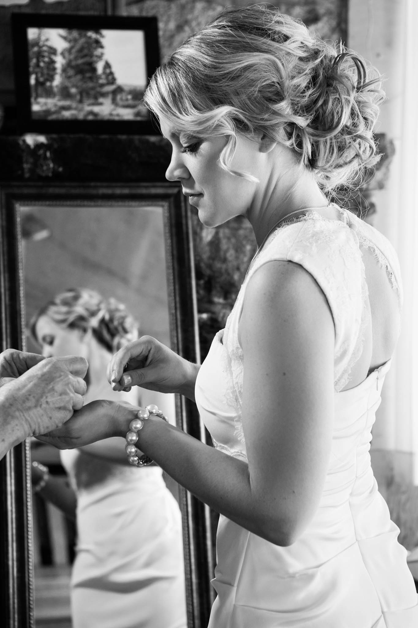 bride getting ready, earrings, mirror – South Lake Tahoe lakefront beach wedding nina photographer