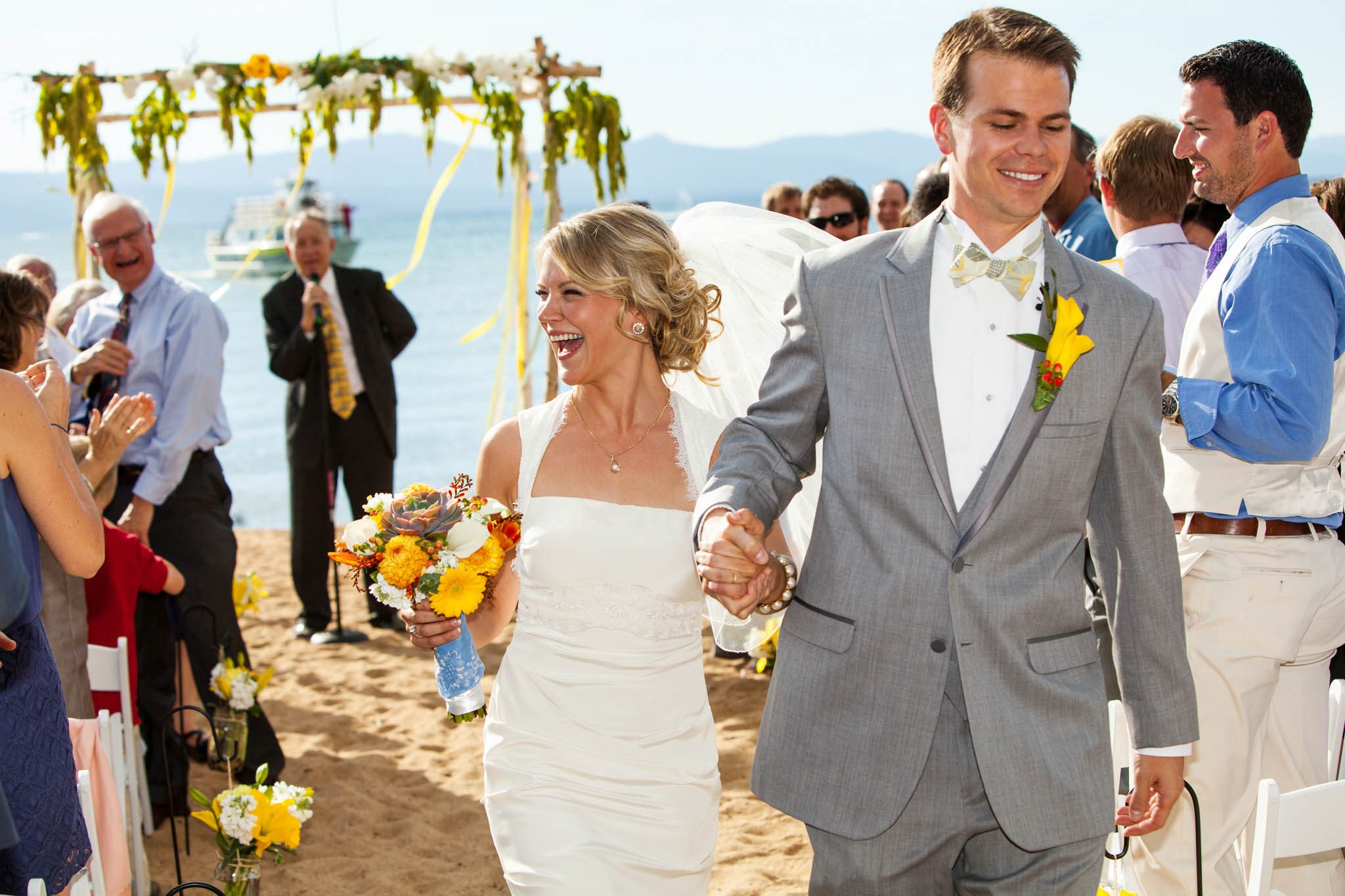 bride and groom recession, laughing – South Lake Tahoe lakefront beach wedding nina photographer