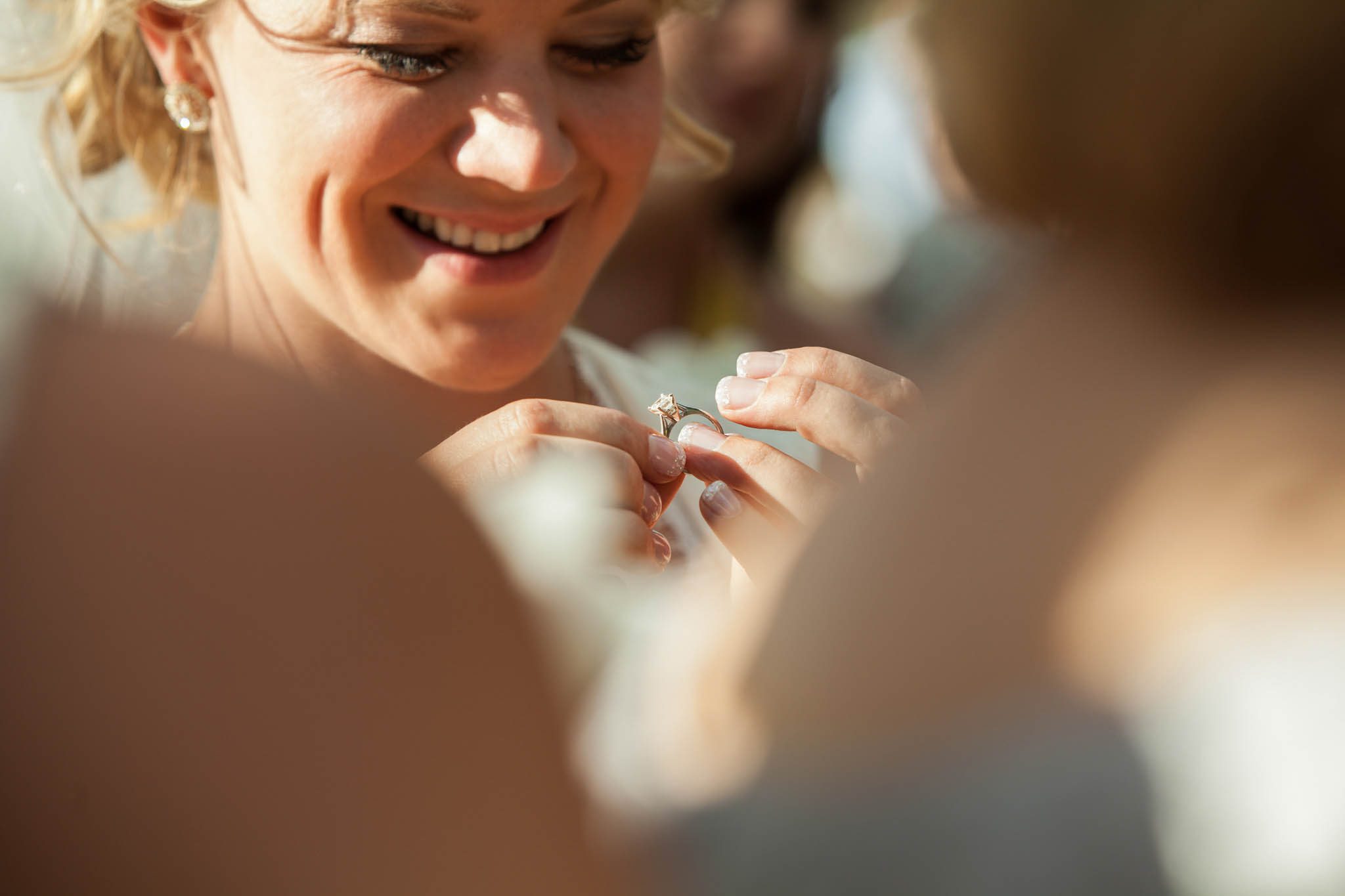 candid of bride looking at engagement ring – South Lake Tahoe lakefront beach wedding nina photographer