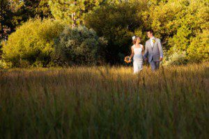 bride and groom walking in meadow – South Lake Tahoe lakefront beach wedding nina photographer