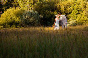 bride and groom portrait, kissing, in meadow – South Lake Tahoe lakefront beach wedding nina photographer