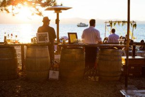 reception candid, bar at sunset – South Lake Tahoe lakefront beach wedding nina photographer