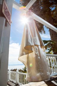 bride's dress deck sun flare – Fairwinds Tahoe wedding photography