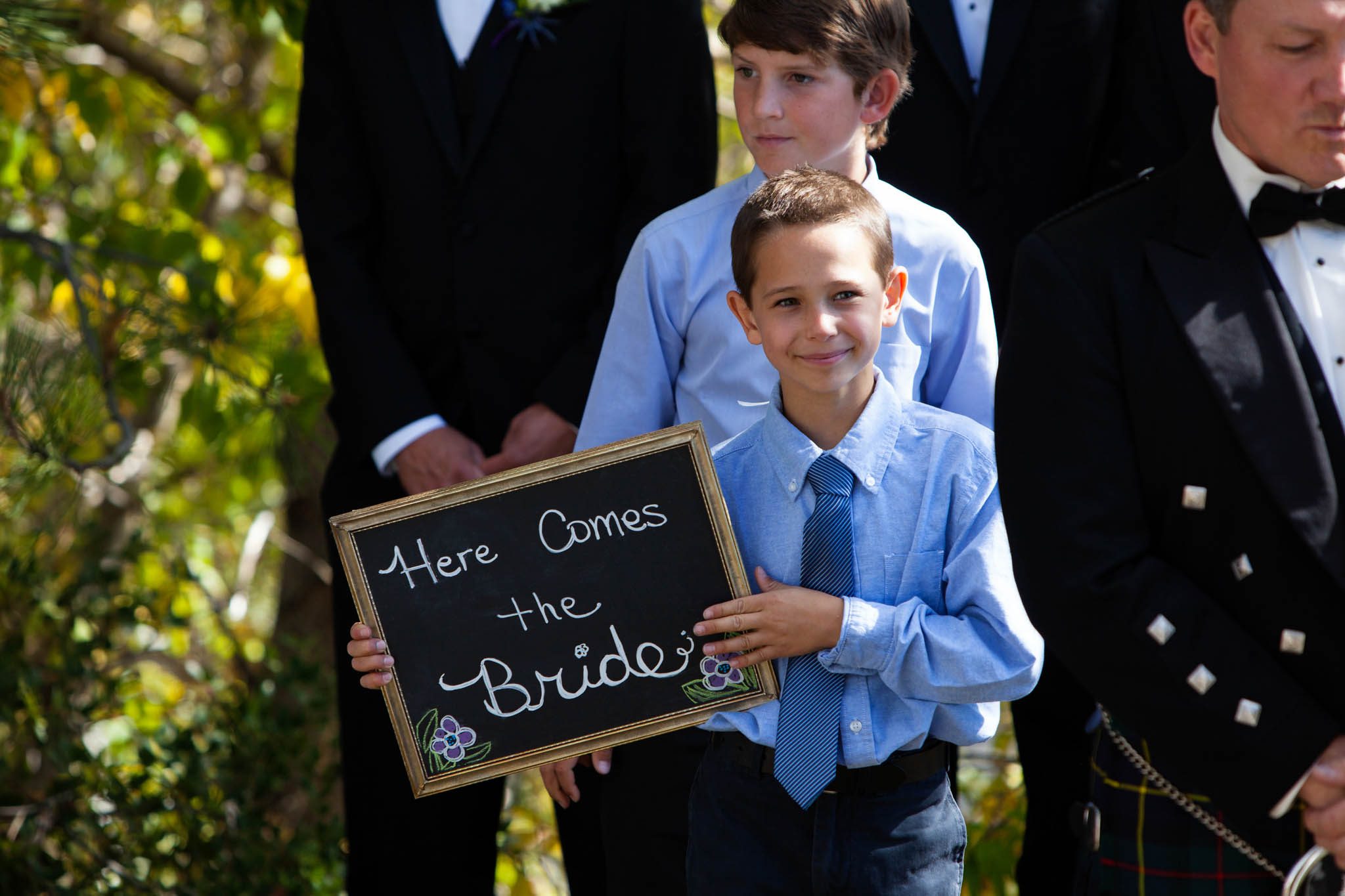 boy with sign here comes the bride ceremony – Fairwinds Tahoe wedding photography