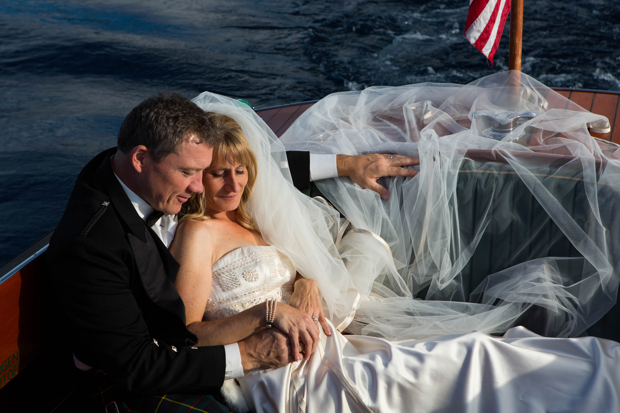 bride groom portrait on wooden boat on lake – Fairwinds Tahoe wedding photography