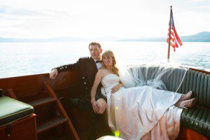 bride groom wooden boat sun flare on lake – Fairwinds Tahoe wedding photography