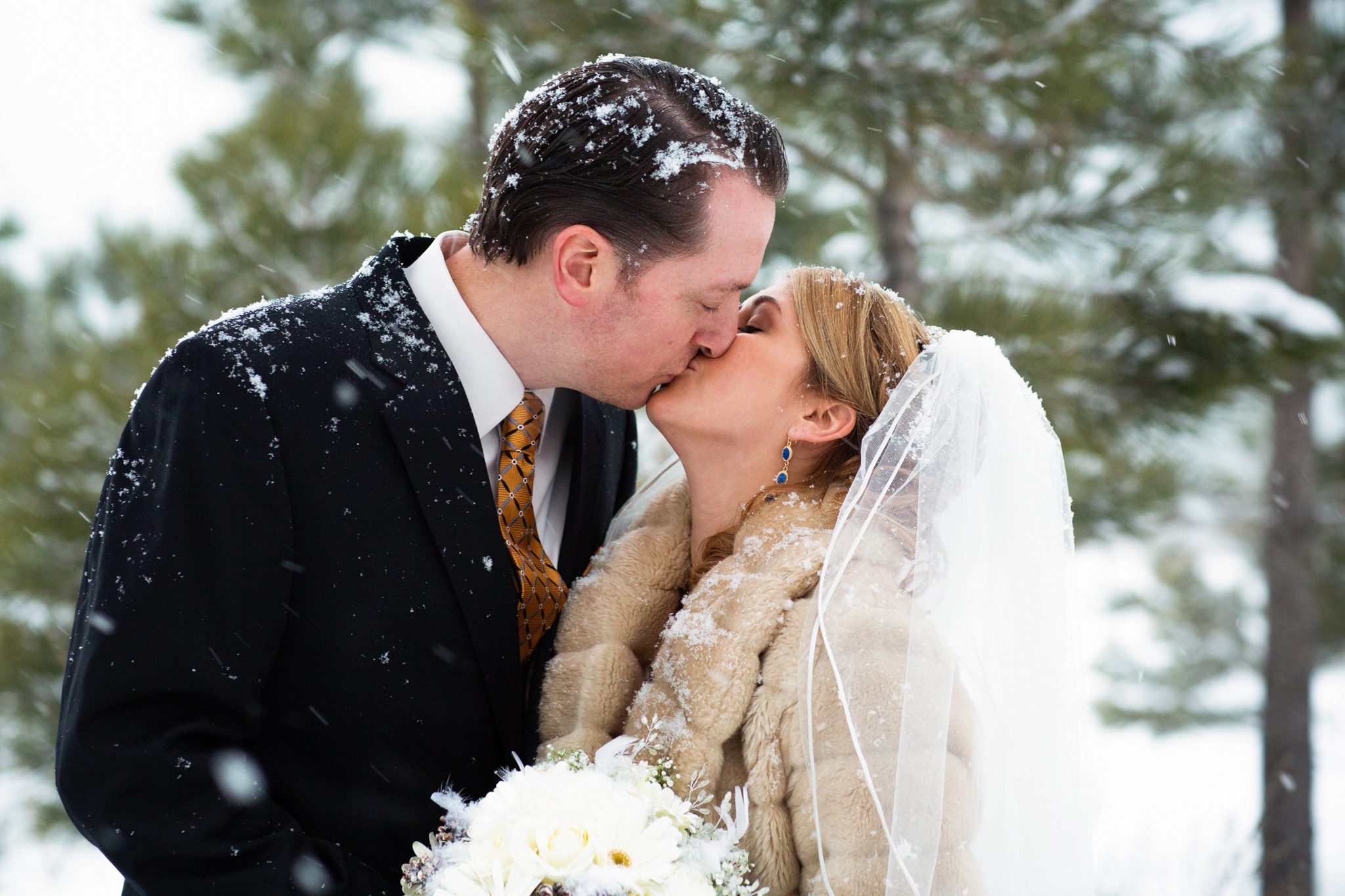 winter wedding bride groom close-up portrait kissing in snow