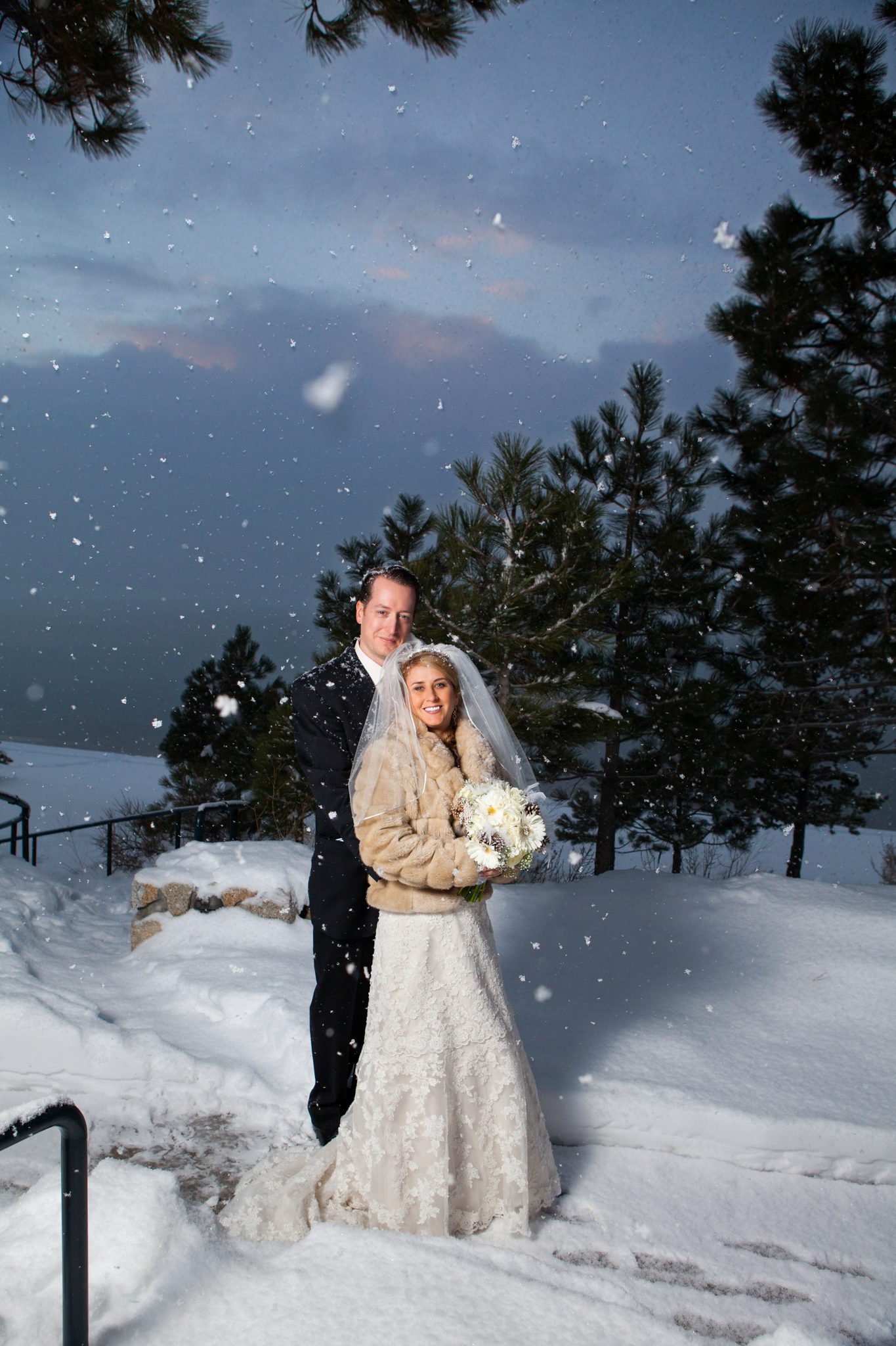 winter wedding bride groom standing in snow smiling