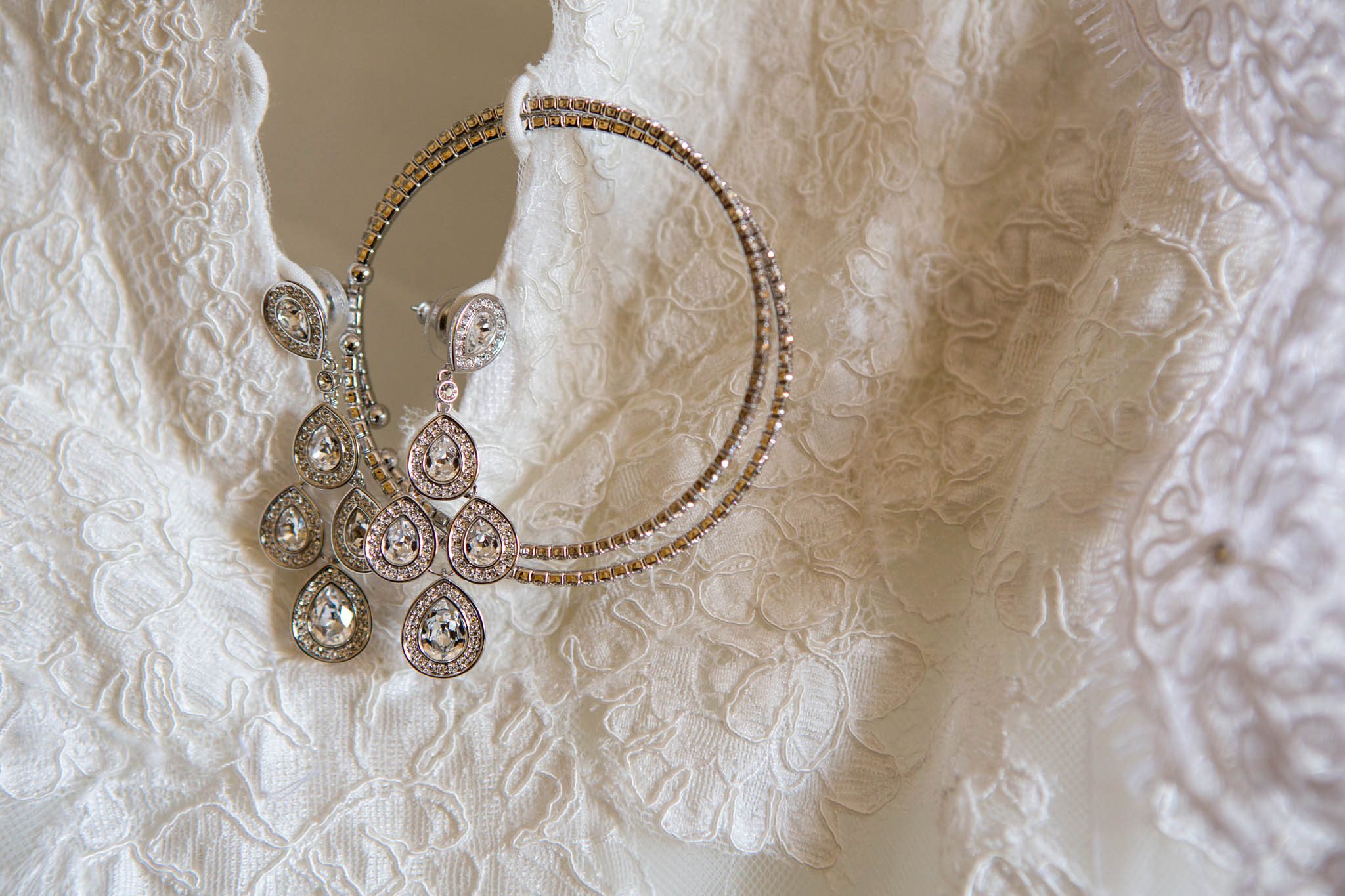 bride's dress detail, lace, earrings, bracelet