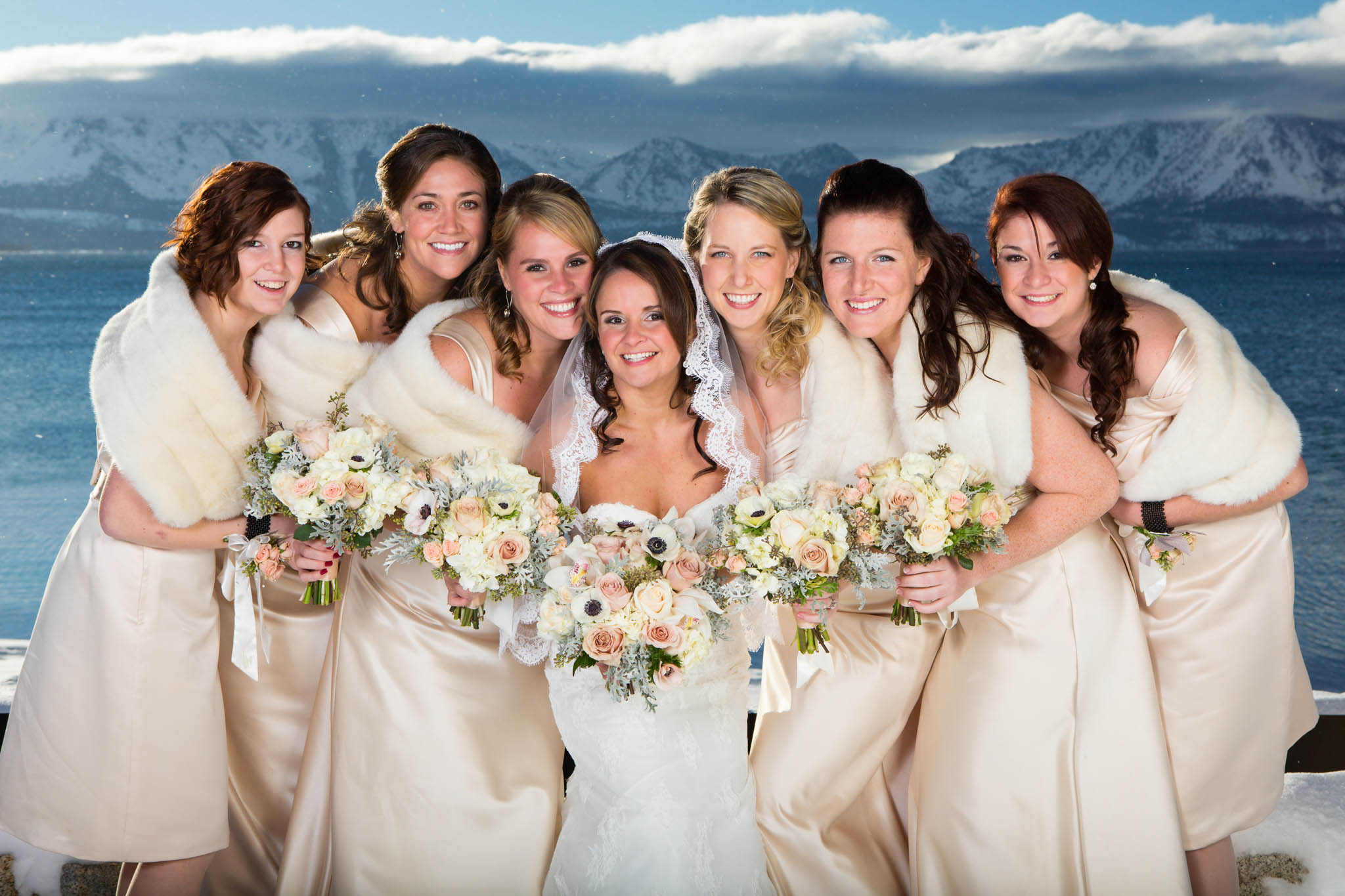 bride and bridesmaids, champagne bridesmaids' dresses, white bouquets, snow, winter, lake, blue