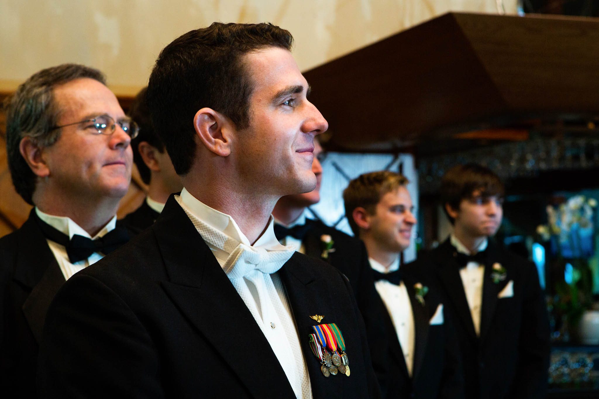 groom waiting for his bride, ceremony, smiling, uniform
