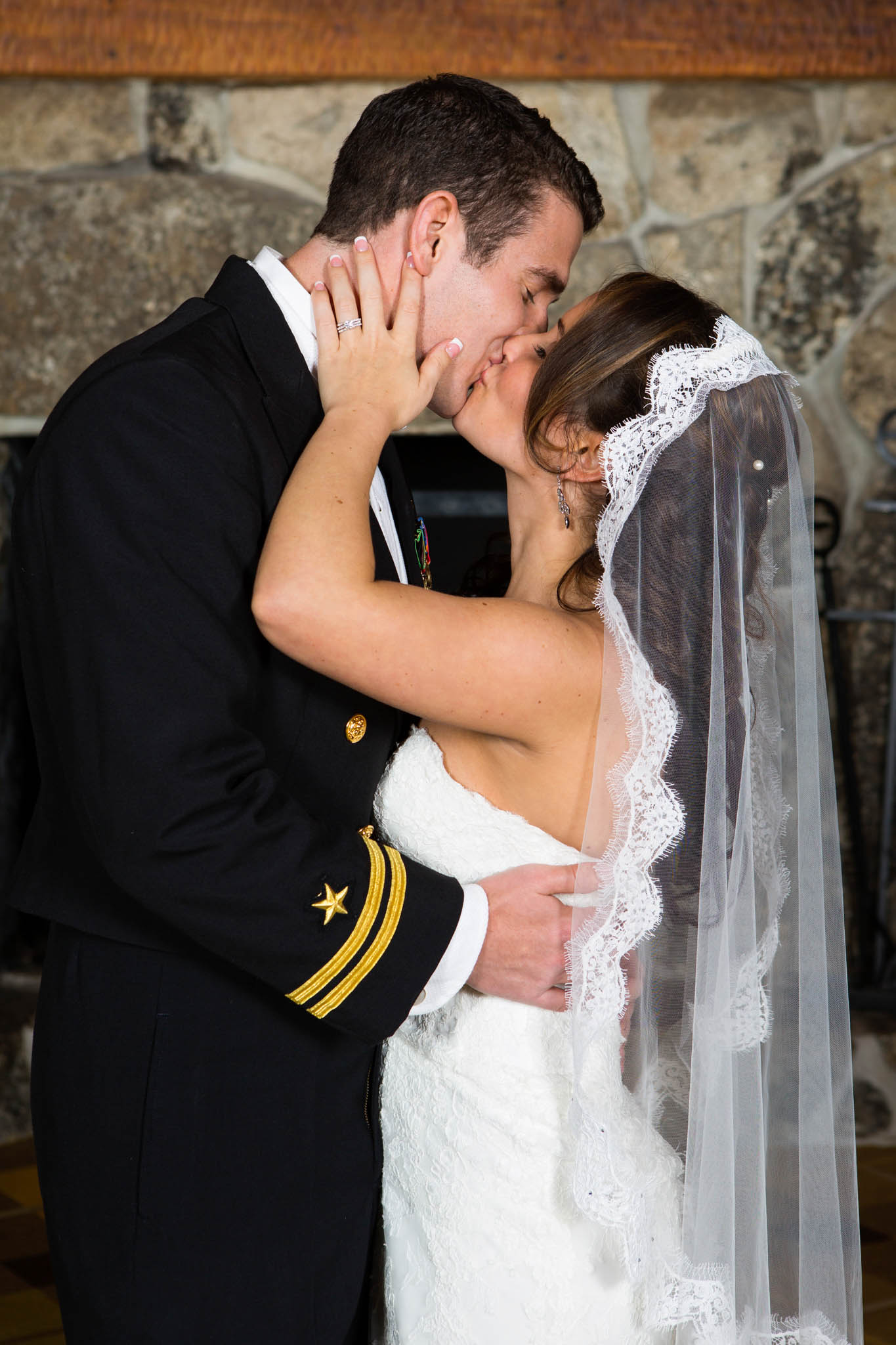 bride and groom kissing, fireplace, veil, lace 