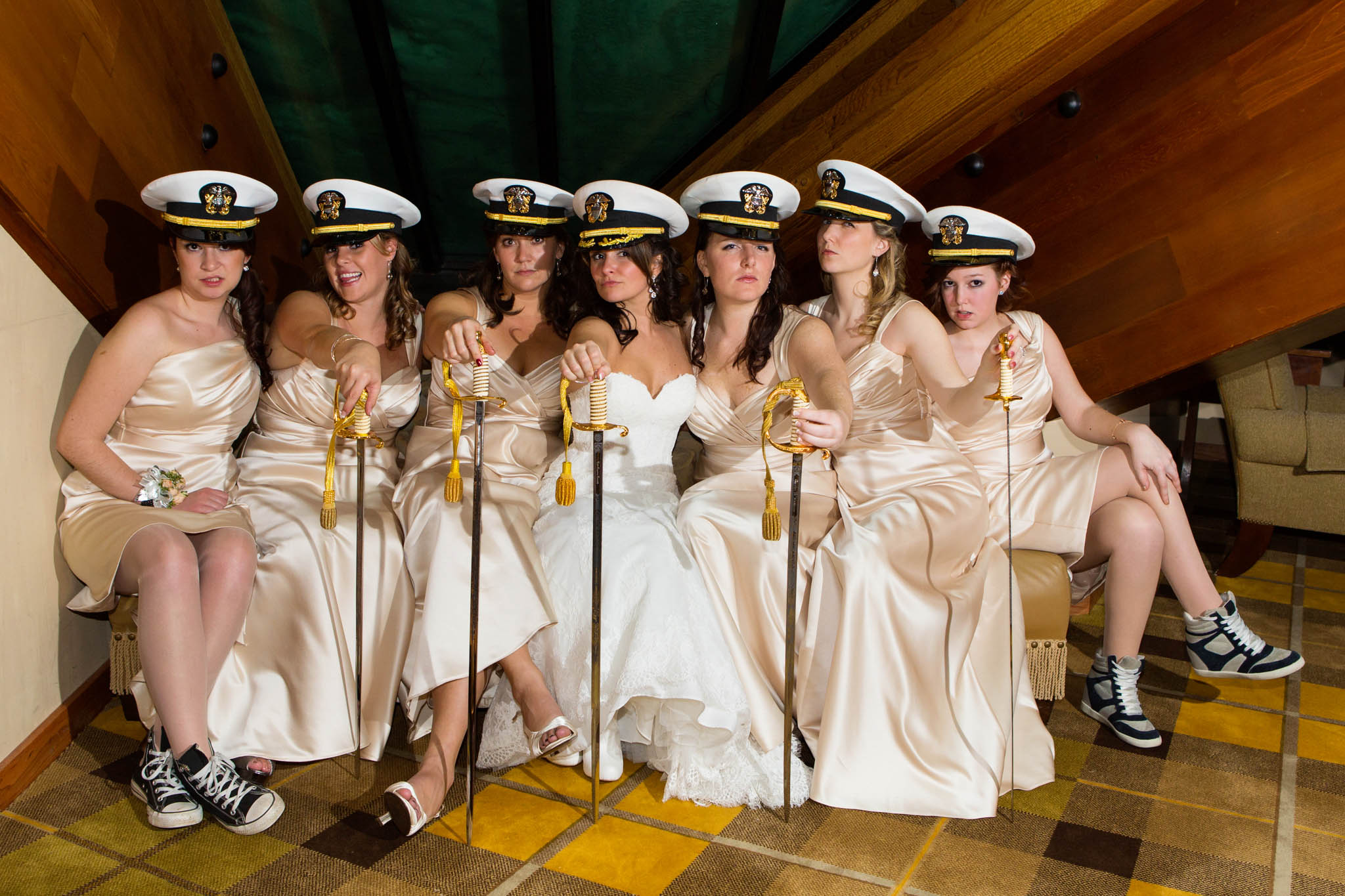 bride and bridesmaids posing with military hats and sabers, fun, attitude, champagne bridesmaids dresses