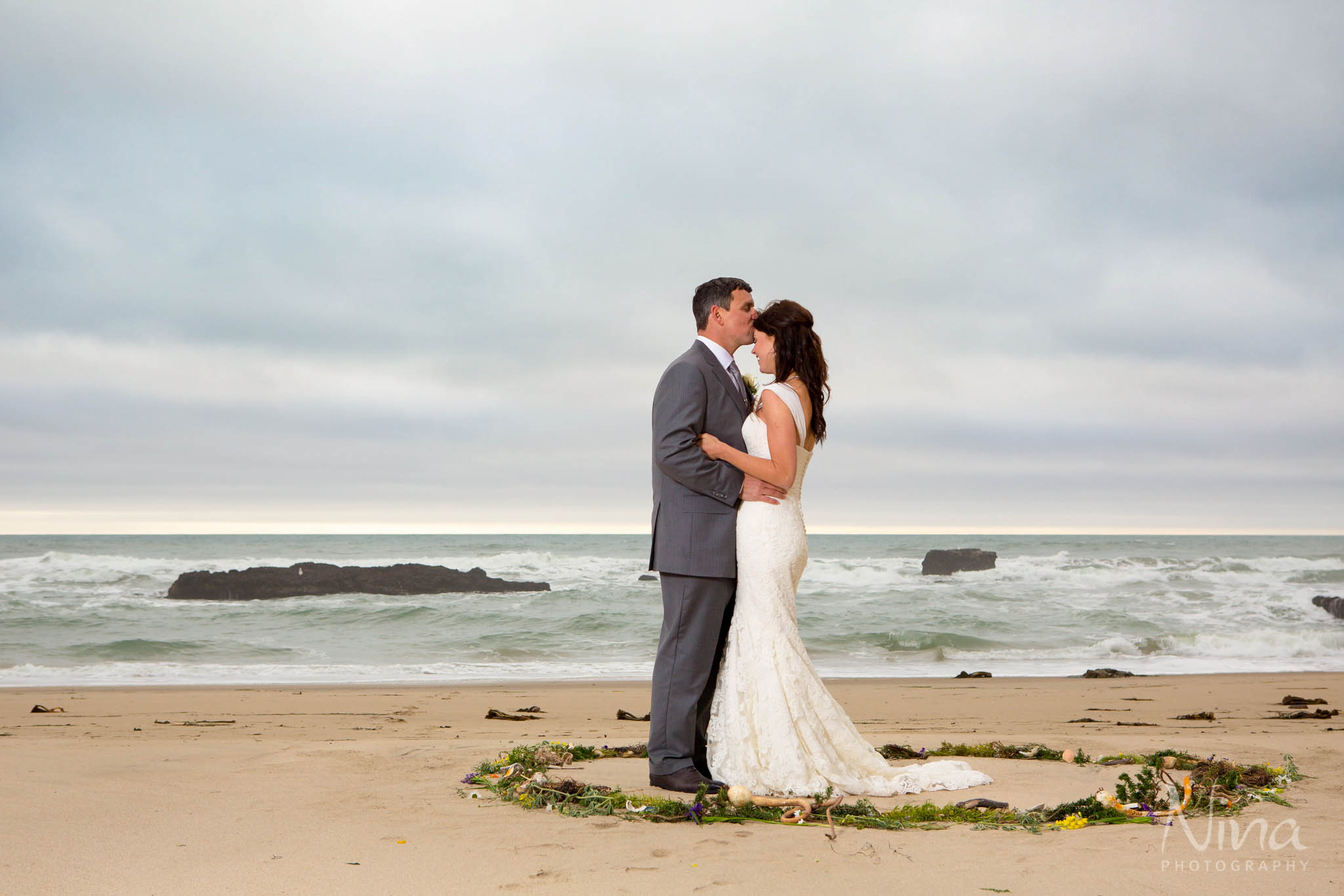 bride groom on beach ocean portrait photography