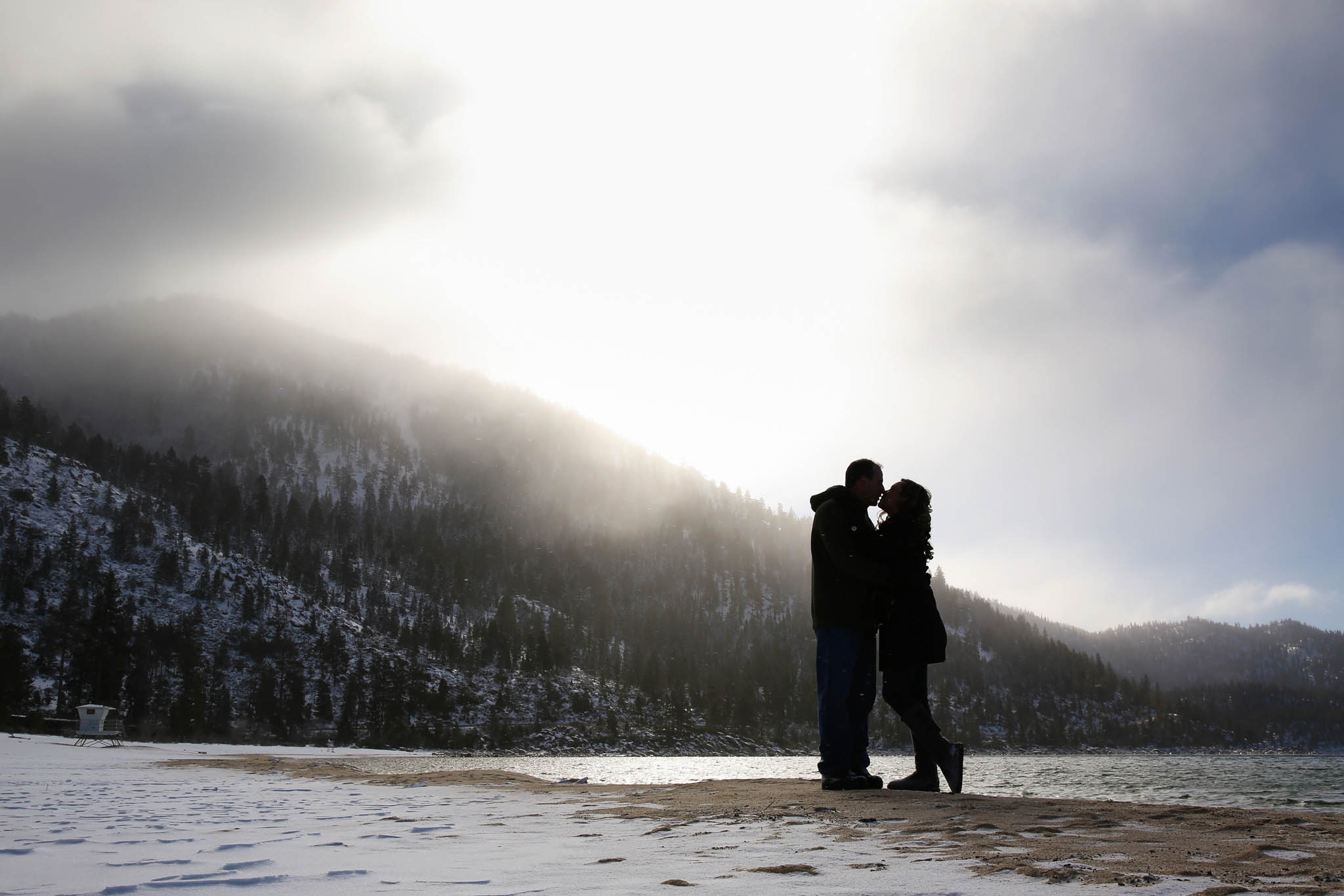 couple kissing on beach, silhouette, golden light