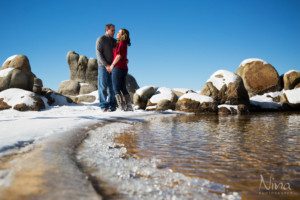 couple portrait on beach, holding hands, low angle, ice, blue sky